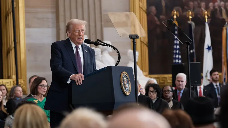 Donald Trump speaking at a lectern in the Capitol Rotunda